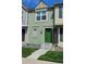 Charming two-story townhouse with a green exterior, landscaped front yard, and inviting entrance at 1641 S Idalia Cir # F, Aurora, CO 80017
