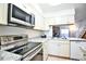 Modern kitchen with stainless steel appliances, granite countertops, and bright white cabinetry at 1641 S Idalia Cir # F, Aurora, CO 80017