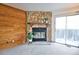 Close up of the stone fireplace, wood accent wall, and sliding glass door in the living room at 1641 S Idalia Cir # F, Aurora, CO 80017