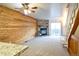 Living room with ceiling fan, wood accent wall, stone fireplace, and sliding glass door to the backyard at 1641 S Idalia Cir # F, Aurora, CO 80017