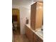 Bathroom with double sinks, wood cabinets, yellow accent wall and tile floors at 1888 S Jackson St # 404, Denver, CO 80210