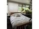 Inviting bedroom filled with natural light from the large windows and adorned with numerous plants at 1888 S Jackson St # 404, Denver, CO 80210