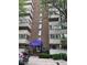 Wellington Square Condominiums shows a brick building with balconies and a blue awning over the entrance at 1888 S Jackson St # 404, Denver, CO 80210