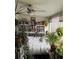 Cozy living room filled with plants and books with a ceiling fan and white daybed at 1888 S Jackson St # 404, Denver, CO 80210