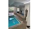 Bright indoor pool with tile floors and multiple doors to exterior at 1888 S Jackson St # 404, Denver, CO 80210
