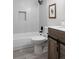 Bathroom featuring a toilet, bathtub with black fixtures, and a vanity with sliding door cabinet at 7395 E Eastman Ave # 202N, Denver, CO 80231