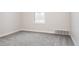Empty bedroom with light neutral carpet, white trim, and neutral walls at 7395 E Eastman Ave # 202N, Denver, CO 80231
