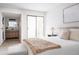 Bright bedroom featuring balcony doors, bathroom, laundry, and neutral finishes at 7395 E Eastman Ave # 202N, Denver, CO 80231