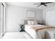 Bright bedroom with a ceiling fan and a comfortable bed with an abstract wall art at 7395 E Eastman Ave # 202N, Denver, CO 80231