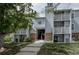 Three-story apartment building with stairs leading to the units and mature trees providing shade at 7395 E Eastman Ave # 202N, Denver, CO 80231
