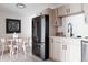 Kitchen area featuring stainless steel appliances, light wood cabinets, and eat-in dining area at 7395 E Eastman Ave # 202N, Denver, CO 80231