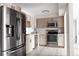 Kitchen with stainless steel appliances, modern wood cabinets and white subway tile backsplash at 7395 E Eastman Ave # 202N, Denver, CO 80231