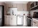Modern kitchen with stainless steel appliances, light wood cabinetry, and subway tile backsplash at 7395 E Eastman Ave # 202N, Denver, CO 80231
