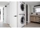Stacked washer and dryer with a view into the bathroom at 7395 E Eastman Ave # 202N, Denver, CO 80231