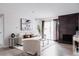 Bright living room with a stone fireplace and sliding glass doors to the outside balcony at 7395 E Eastman Ave # 202N, Denver, CO 80231