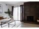 Bright living room showing fireplace, balcony, modern decor, and neutral finishes at 7395 E Eastman Ave # 202N, Denver, CO 80231