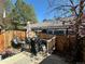 Outdoor deck area with wooden fence, seating, and grill, ideal for backyard relaxation at 11576 E Bayaud Dr, Aurora, CO 80012