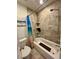 Cozy bathroom featuring a tub and shower combination, tiled walls, and beach-themed decor at 11576 E Bayaud Dr, Aurora, CO 80012