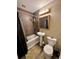 Well-lit bathroom featuring a pedestal sink, toilet, and shower-tub combo with neutral colors at 11576 E Bayaud Dr, Aurora, CO 80012