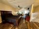 Bedroom with a ceiling fan, wood-look flooring, and plenty of natural light from unique shaped windows at 11576 E Bayaud Dr, Aurora, CO 80012