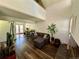 Bright living room with high ceilings, hardwood floors, and access to an outdoor patio at 11576 E Bayaud Dr, Aurora, CO 80012