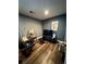 Comfortable living room with hardwood floors, recliner chair, and entertainment center, perfect for relaxation at 11576 E Bayaud Dr, Aurora, CO 80012