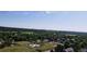 Expansive aerial view of a lush neighborhood with mature trees and meticulously maintained landscaping under a clear blue sky at 8960 W Dartmouth Pl, Lakewood, CO 80227