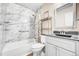 The bathroom features marble-style tile and a modern vanity, showcasing an elegant and functional design at 8960 W Dartmouth Pl, Lakewood, CO 80227