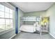 Bright bedroom features a bunk bed and a large window, perfect for a room or guest room at 8960 W Dartmouth Pl, Lakewood, CO 80227