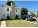 Pleasant townhome exterior featuring green lawn and convenient parking at 8960 W Dartmouth Pl, Lakewood, CO 80227