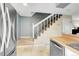 Hallway and staircase of the home with tile and carpet, adjacent to the kitchen at 8960 W Dartmouth Pl, Lakewood, CO 80227