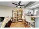 Inviting living area featuring open shelving and seamless flow to the kitchen at 8960 W Dartmouth Pl, Lakewood, CO 80227