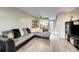 Bright and airy living room featuring stylish sofa and access to the kitchen at 8960 W Dartmouth Pl, Lakewood, CO 80227