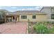 Landscaped backyard with brick patio and covered deck providing outdoor space for entertaining at 17710 E Emilia Dr, Parker, CO 80134
