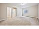 Basement room with neutral carpet, a window well, and access to closet at 17710 E Emilia Dr, Parker, CO 80134