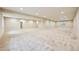 Bright basement space with neutral carpet, recessed lighting, and ample room for recreation or storage at 17710 E Emilia Dr, Parker, CO 80134