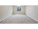 Spacious bedroom featuring neutral walls, gray carpeting, and a large window for ample light at 17710 E Emilia Dr, Parker, CO 80134