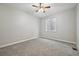 Inviting bedroom showcasing neutral walls, gray carpeting, a ceiling fan, and a window for natural light at 17710 E Emilia Dr, Parker, CO 80134