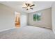 Spacious bedroom featuring plush gray carpeting and a view of lush green hills at 17710 E Emilia Dr, Parker, CO 80134