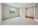Bright bedroom with carpet, a large window, and French doors leading to another room at 17710 E Emilia Dr, Parker, CO 80134