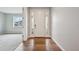 Bright entryway with hardwood floors, sidelights, and views into the adjacent living area at 17710 E Emilia Dr, Parker, CO 80134