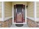 Inviting front entryway with a decorative wood door, stone accents, and sidelights for added natural light at 17710 E Emilia Dr, Parker, CO 80134