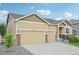 Charming single-Gathering home featuring a three-car garage, stone accents, and a well-manicured front lawn at 17710 E Emilia Dr, Parker, CO 80134