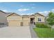 Charming single-Gathering home featuring a three-car garage, stone accents, and a well-manicured front lawn at 17710 E Emilia Dr, Parker, CO 80134