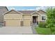 Charming single-Gathering home featuring a three-car garage, stone accents, and a well-manicured front lawn at 17710 E Emilia Dr, Parker, CO 80134
