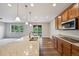 Eat-in kitchen with wood cabinets, a granite countertop island, and stainless steel appliances at 17710 E Emilia Dr, Parker, CO 80134
