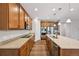 An open kitchen showcasing wooden floors, stainless steel appliances, and granite countertops at 17710 E Emilia Dr, Parker, CO 80134