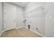 Functional laundry room featuring tile floors, shelving, and essential hookups for appliances at 17710 E Emilia Dr, Parker, CO 80134