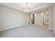 Expansive living room featuring gray carpeting, recessed lighting, and an open hallway with a staircase at 17710 E Emilia Dr, Parker, CO 80134