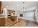 Spacious living area showcasing an eat-in kitchen, fireplace, and a large carpeted living room at 17710 E Emilia Dr, Parker, CO 80134